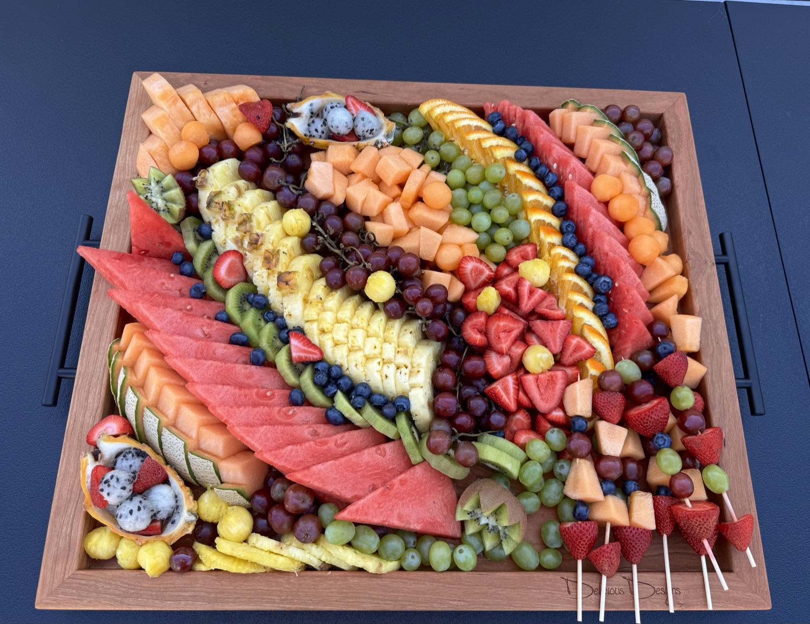 Jumbo fruit platter with carved pineapple, watermelon, dragon fruit and strawberry skewers