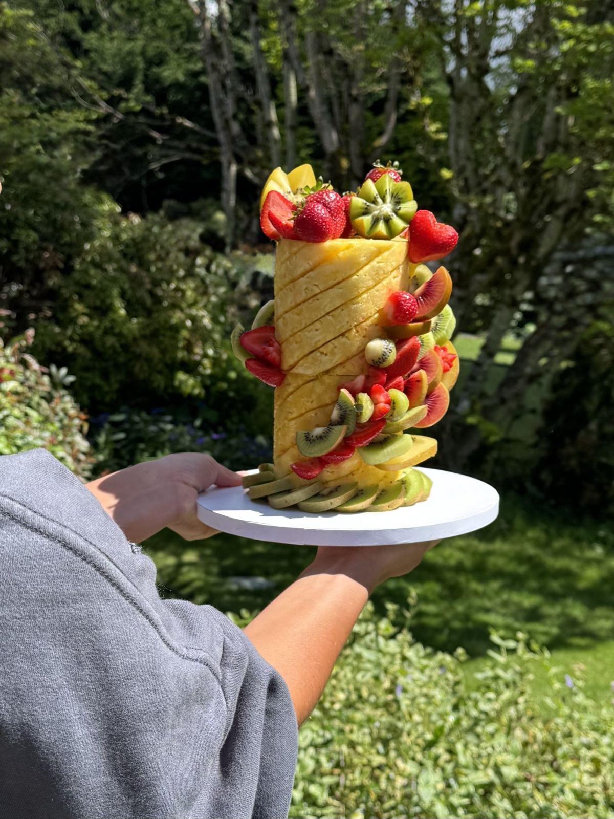 Double twist pineapple cake decorated with strawberries and kiwi